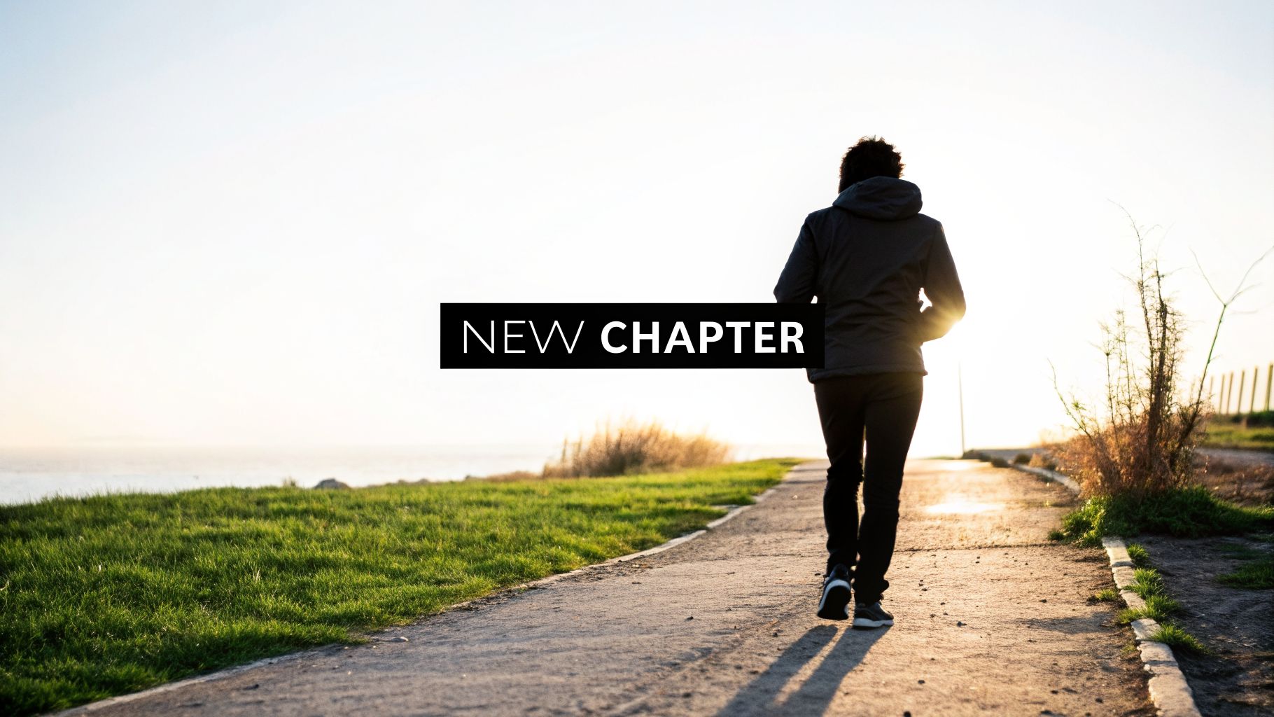 A person walks on a path towards a bright horizon with the text "NEW CHAPTER" symbolizing new beginnings.